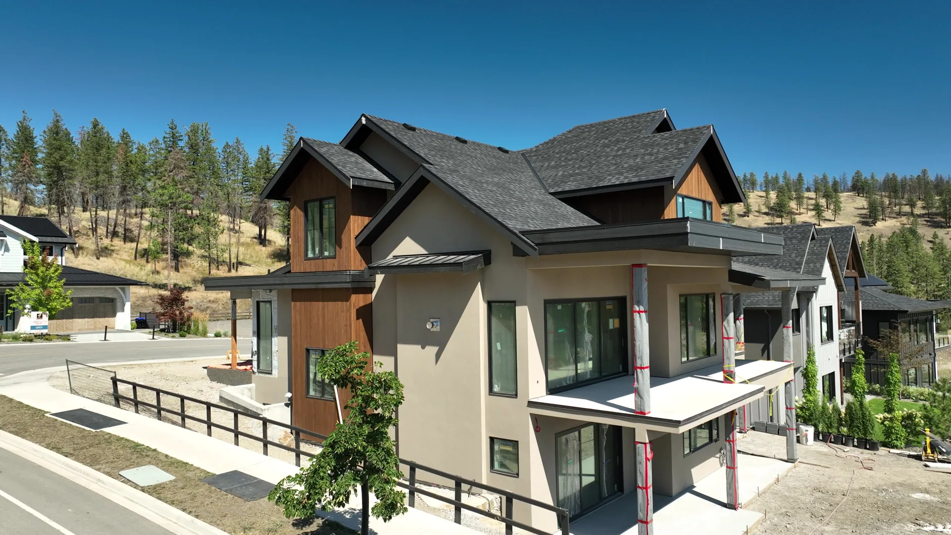 Street elevation of a finished stucco home on a hillside lot.