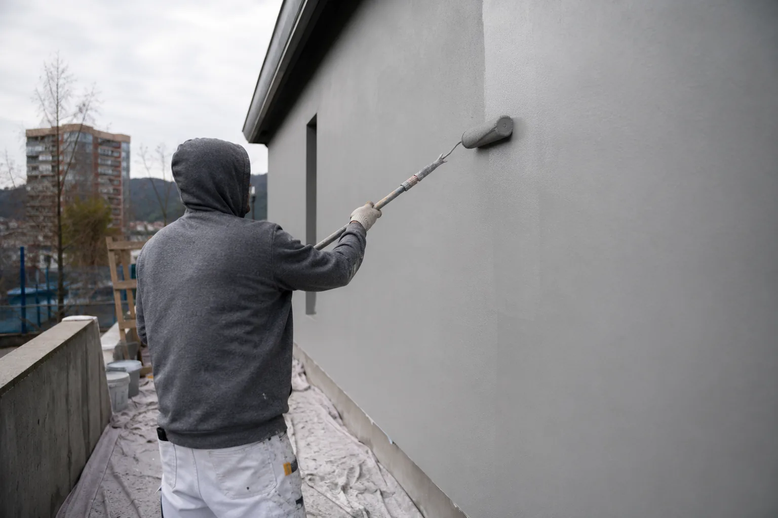Smooth coated exterior wall in raking light.