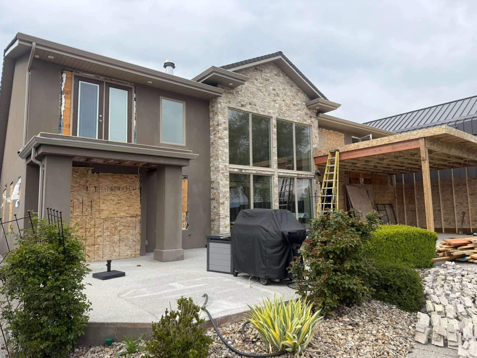Rear elevation of a home part way through an exterior renovation.