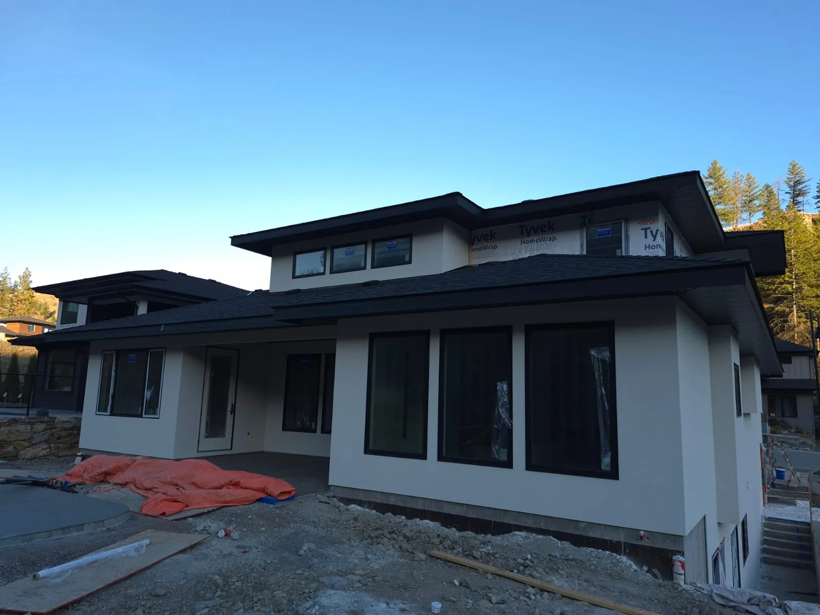 The same patio corner of Lot 42 with the finished light stucco exterior.
