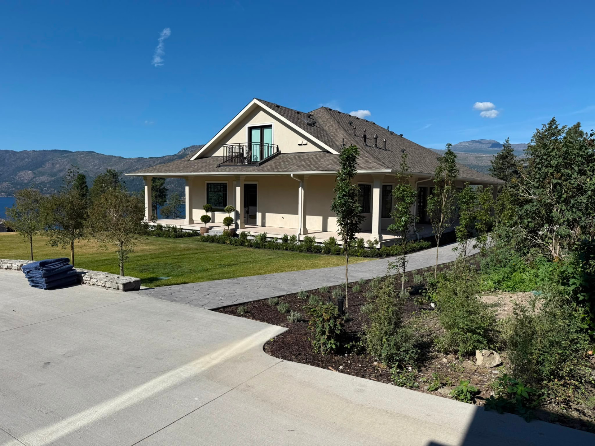 Wrap-around porch and stucco columns at the O’Rouke residence, lake behind.